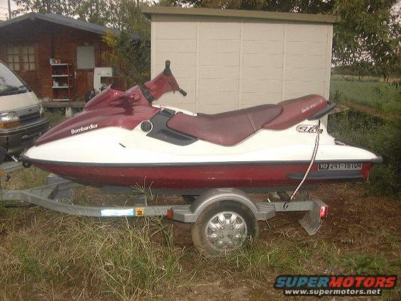 Bombardier jet ski, red and white, on a trailer. Registration number 10 241-16104 visible